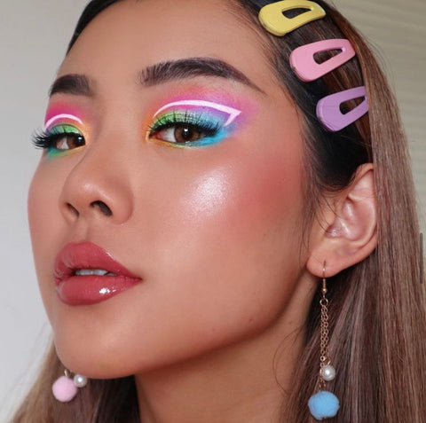 Bright makeup look with colorful hair accessories and earings