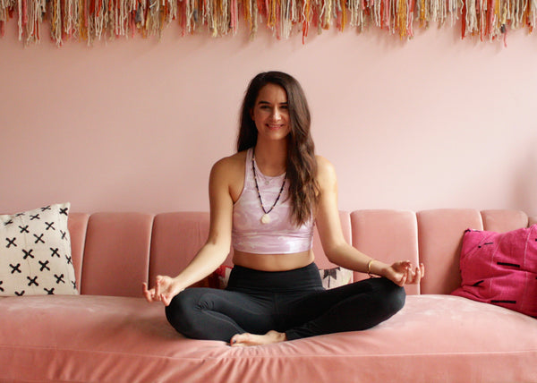 Kasey Dreier smiling while in lotus pose