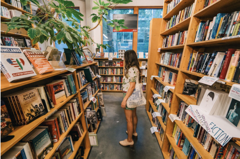 girl browsing books at Powell's Books bookstore