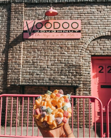 Voodoo doughnut against brick wall with Voodoo Doughnut sign