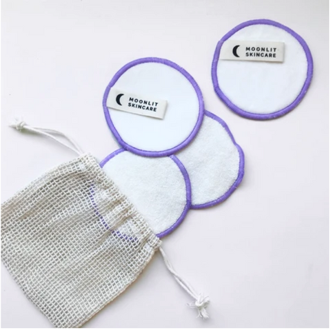 four cotton rounds spread out with a mesh bag