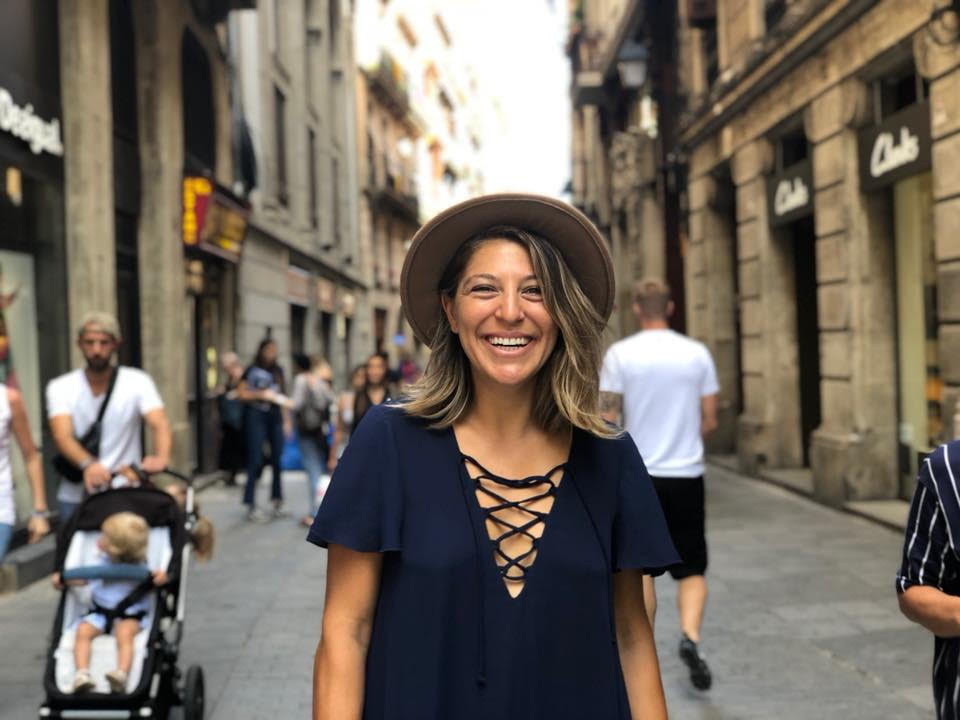 Woman standing and smiling on picturesque European street