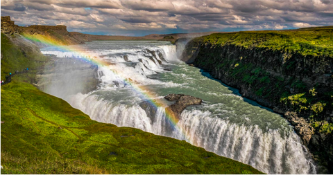 waterfall with rainbow over the water