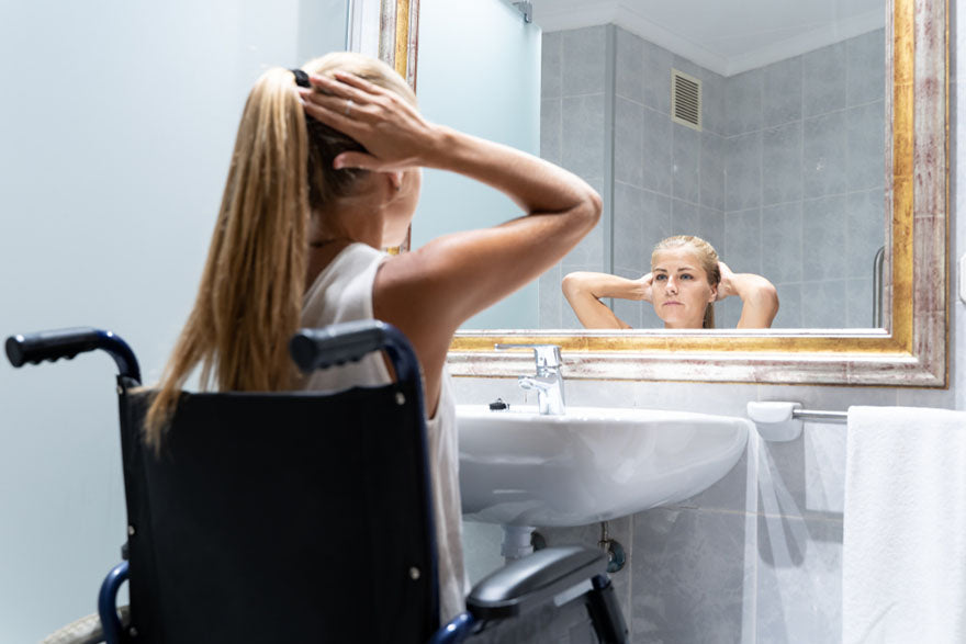 woman wheelchair fixing hair