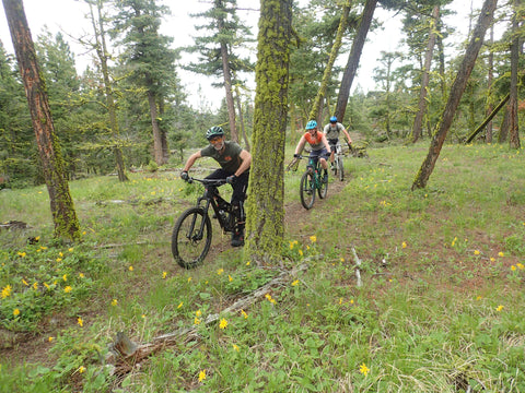 Friends riding mountain bikes on a trail 