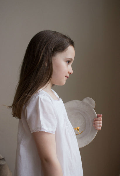 Clay plate for kids with golden glimmers. Shaped like a bear's head. Sabellar and Bonjour. Model in a white dress