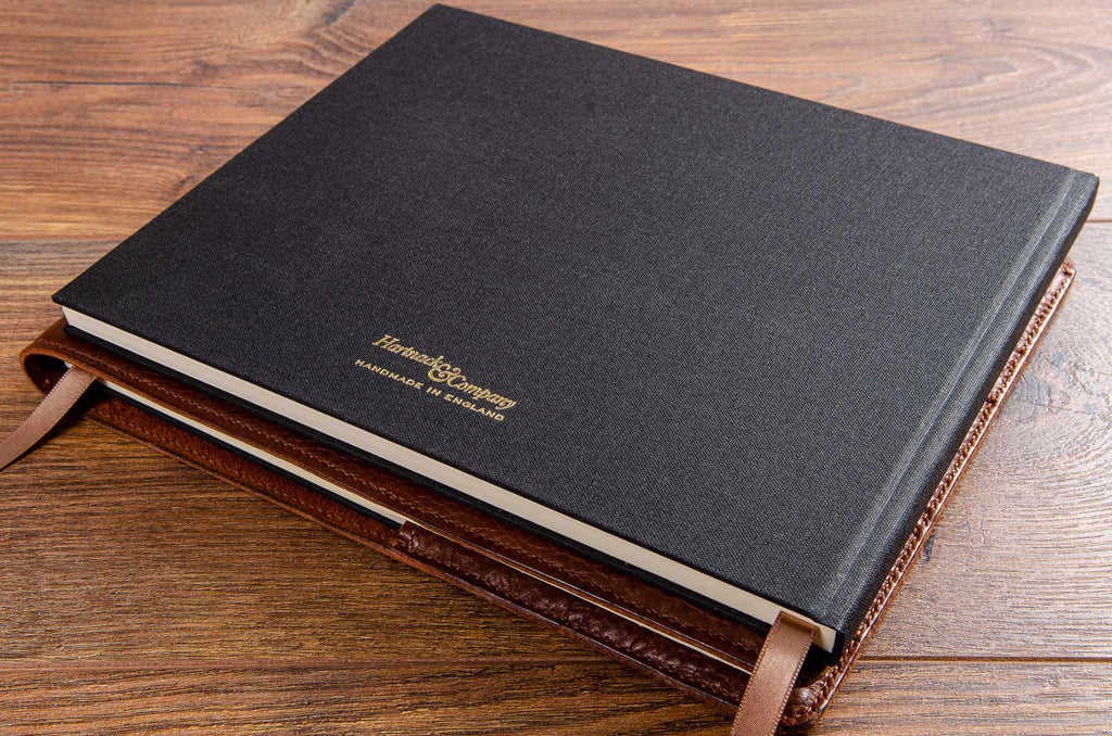 Hard cover guest book and leather book cover hand made by Hartnack and Company England