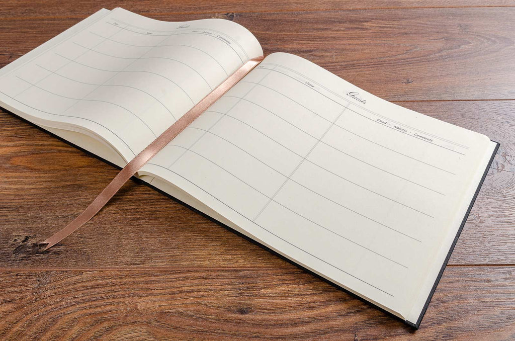 The guest book laid open with ribbon page finder