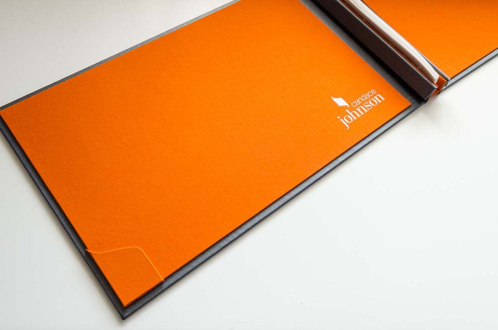 The branding form the front cover has been taken over to the inside covers with a custom business card holder and white foiled personalisation on the solo orange inner cover
