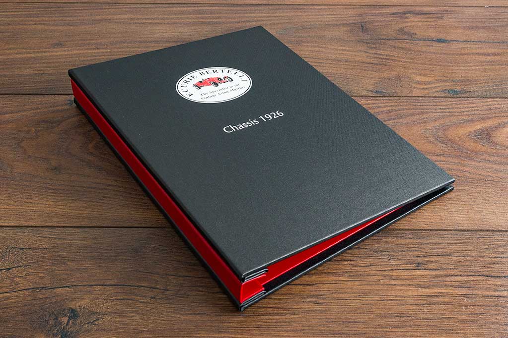 A4 portrait custom vehicle service document binder in black buckram, alton red and a UV printed cover 