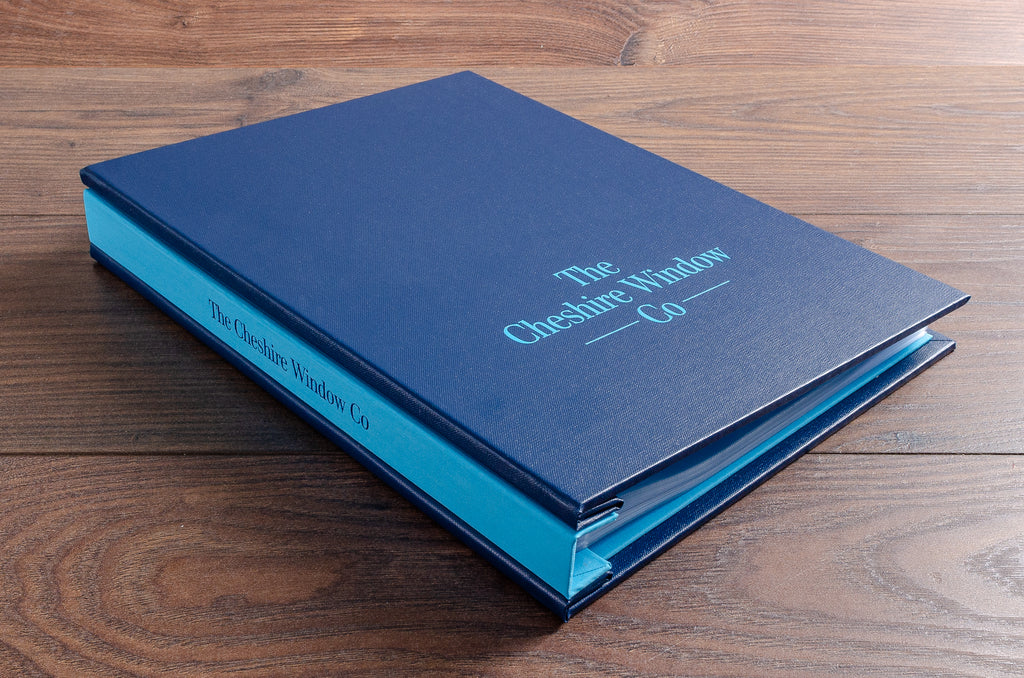 A4 portrait custom sales binder in Petrol blue buckram and Brillianta blue book cloth