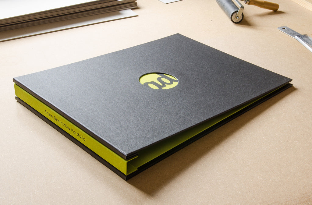 A3 photography portfolio in Charcoal buckram and Doon green inner cover and spine. Also with a round recessed window and black foiled personalisation
