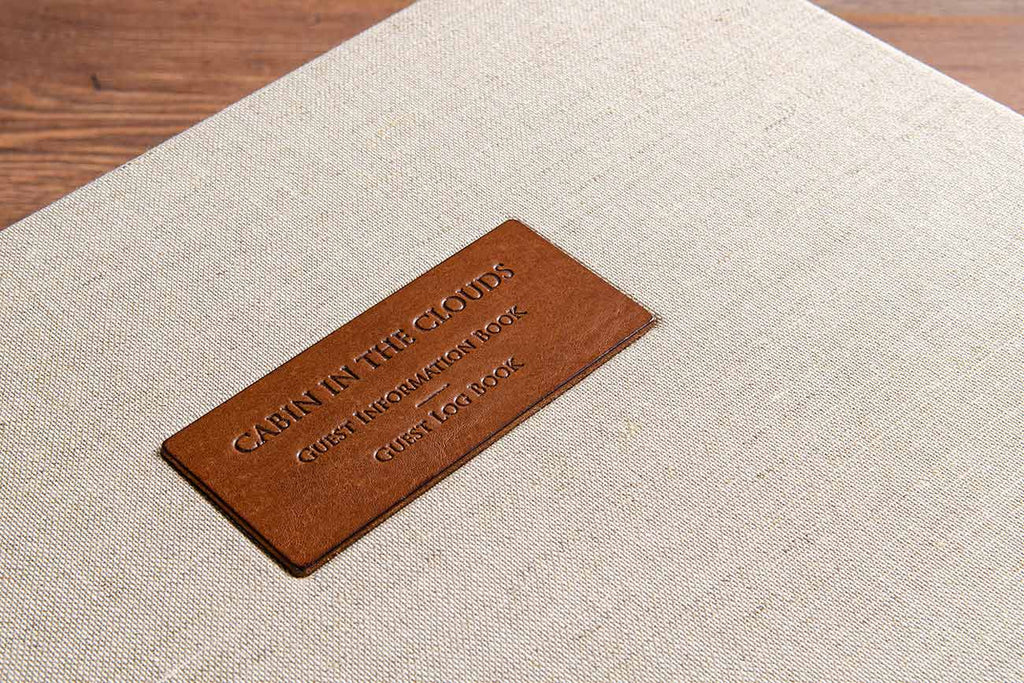 Leather plaque with blind debossed title of guest information book and guest book