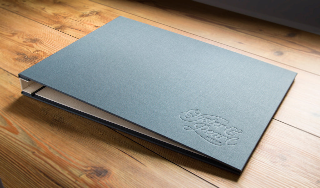 A3 graphic designers portfolio book in Plate book cloth and light linen book cloth with blind debossed logo