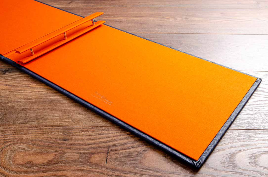 Portfolio book with 3 screw posts for binders and an inner cover in solo orange