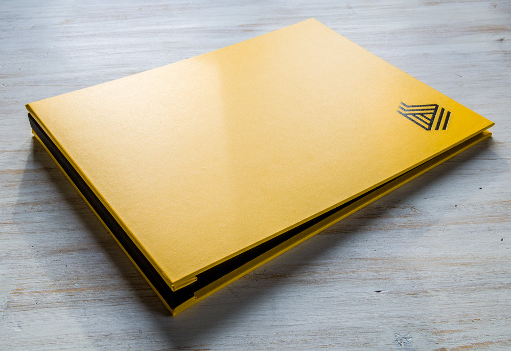 A3 Photographers portfolio book in Yellow buckram and Main black book cloth with lack foiled logo