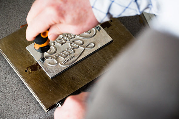 attaching a metal die to personalise a portfolio cover