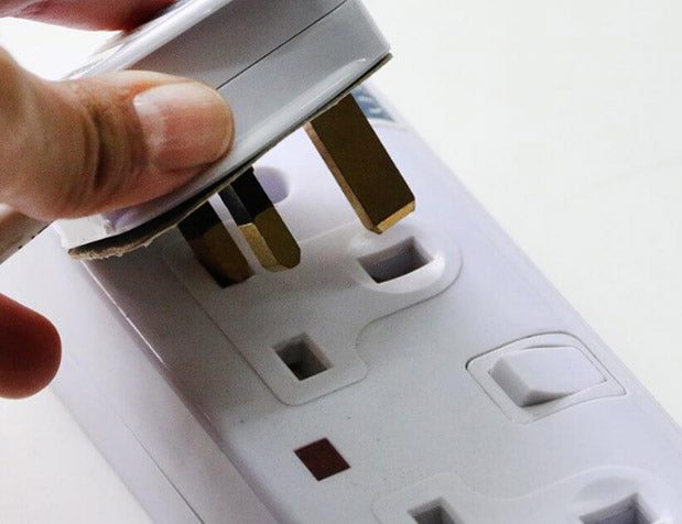 Hand holding plug adapter