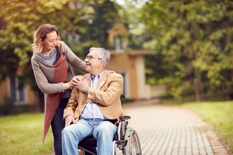 daughter with elderly father in wheel chair.