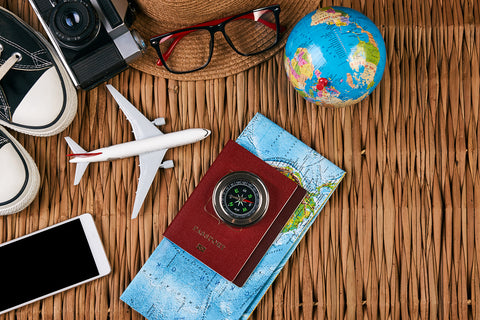 photo of an airplane, glob and passport and map props.