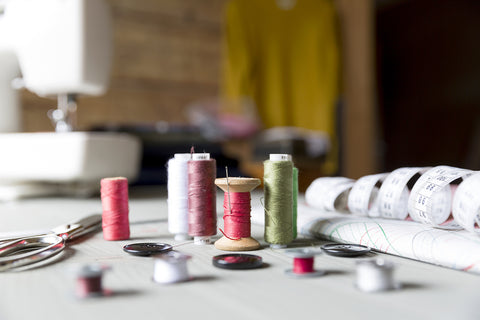 shallow shot of thread spools on a table. 