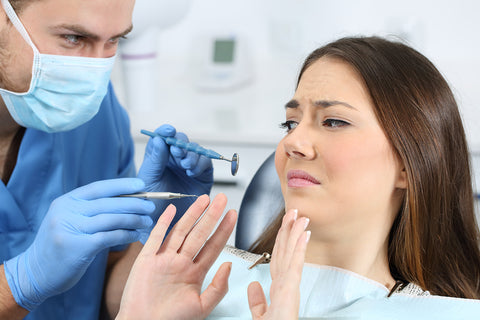 photo of a woman refusing a dental cleaning.