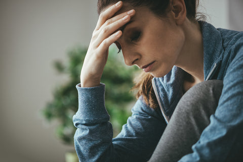 photo of woman with head in her hand. anxiety.