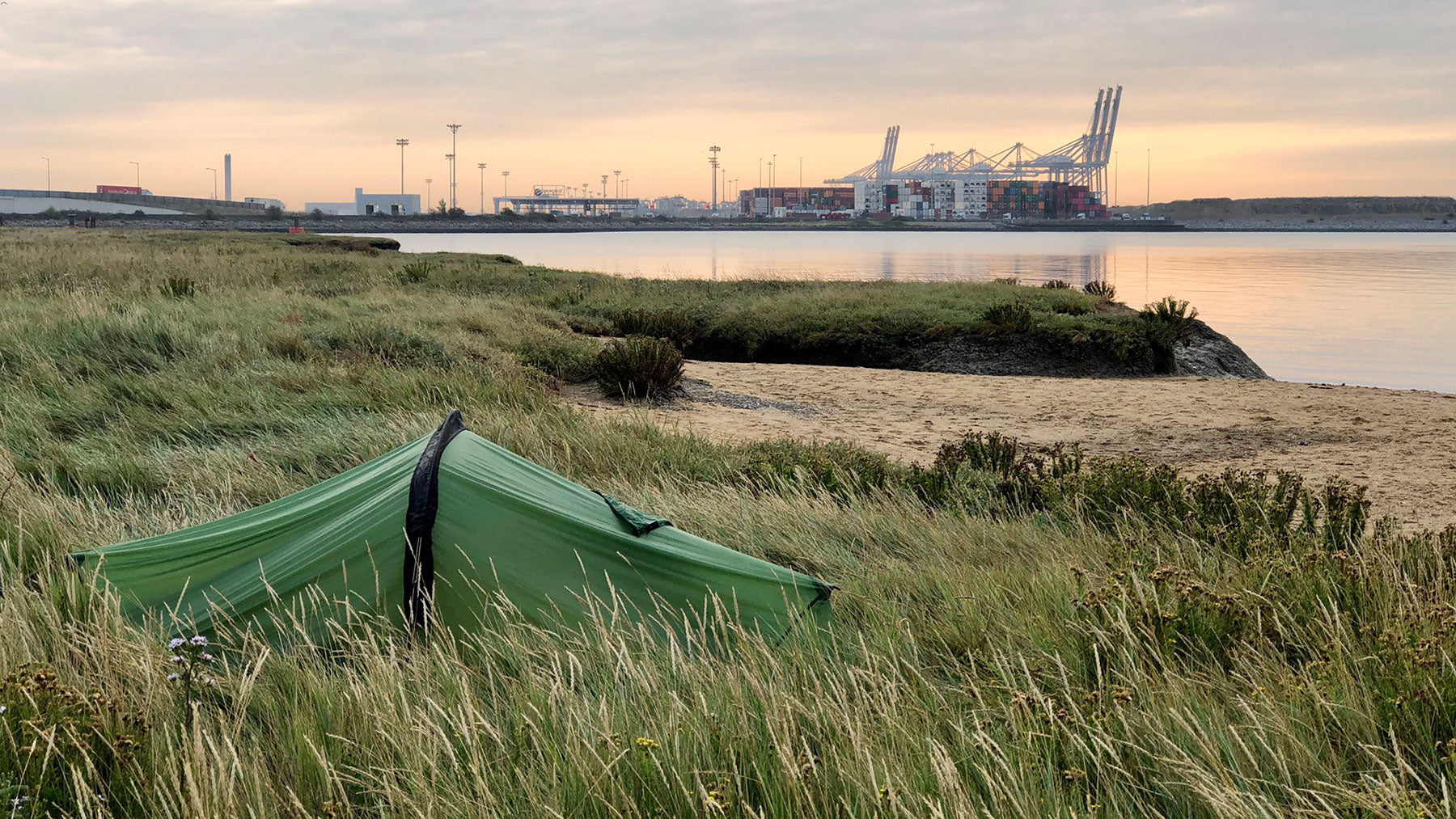 Wild camping in the Thames Estuary, in sight of containers and docks