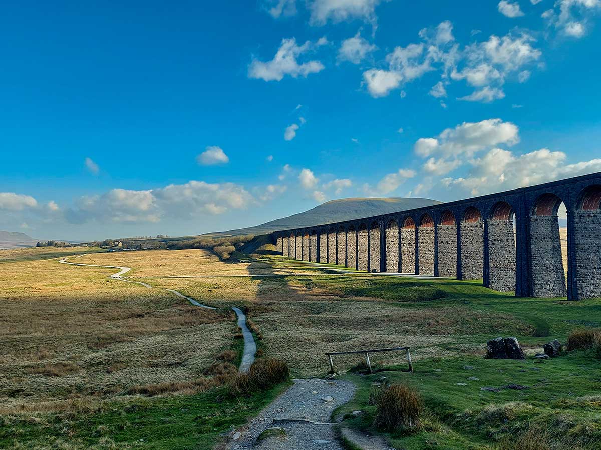 The Ribblehead Viaduct, with Park Fell on the tip of Ingleborough in the background.