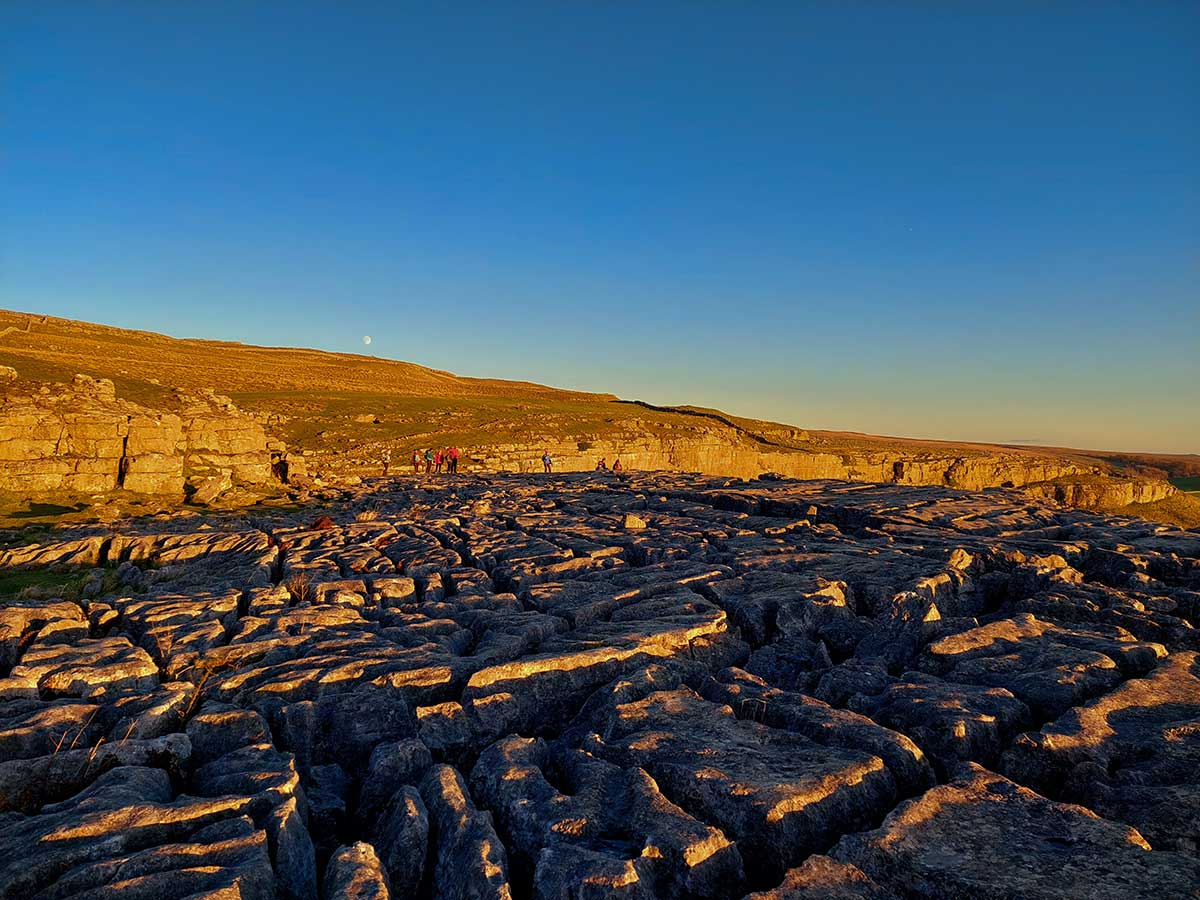 Limestone pavement on top of Malham Cove at Sunset.