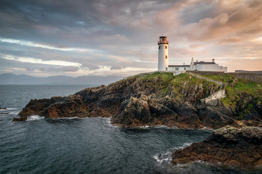 A stunning coastline view of the working Fanad Lighthouse near Lough Swilly and Mulroy Bay in County Donegal, Ireland. 