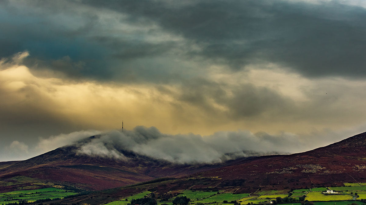 A dramatic sky showing a storm clearing over Mount Leinster in the Blackstair Mountains, County Carlow, Ireland.