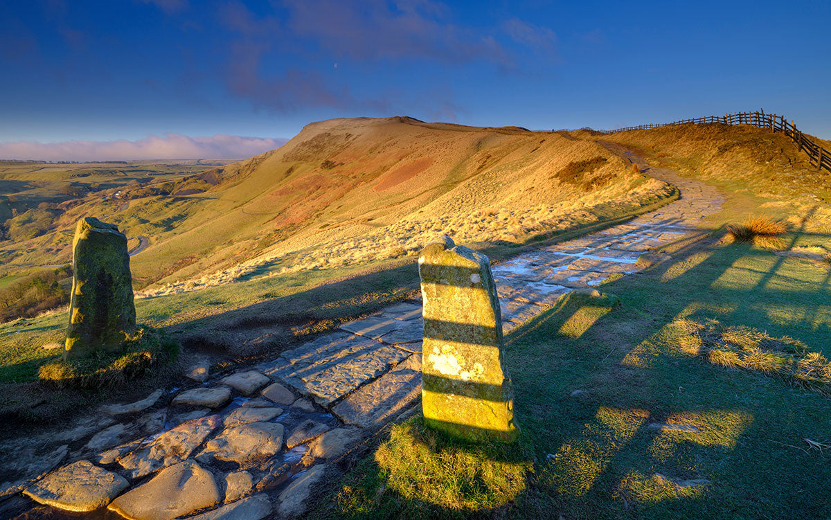 Spring Sunrise on Mam Tor overlooking Edale and the Hope Valley after a clear night with a light dusting of snow.