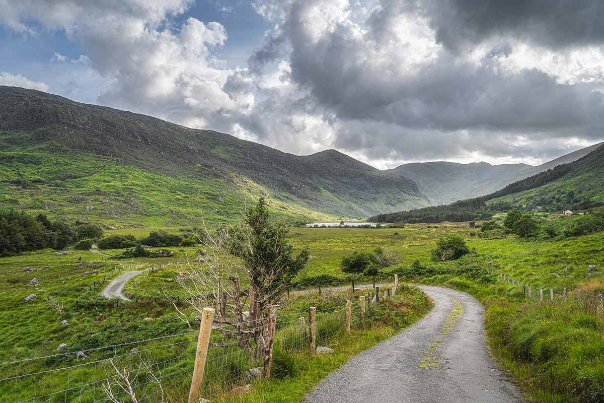 A winding country road passing through the Black Valley in the MacGillycuddy’s Reeks mountain range in County Kerry, Ireland.