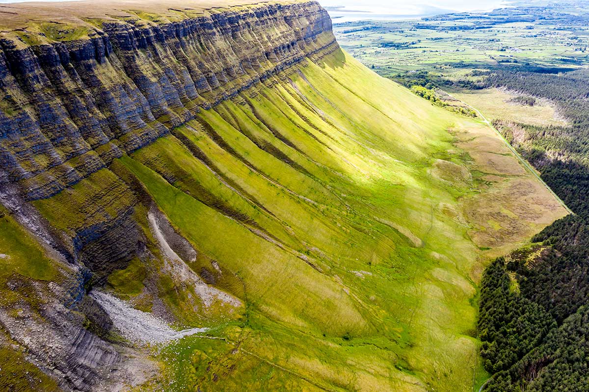 A side view of Benbulben mountain and its ridges and forests in County Sligo, Ireland