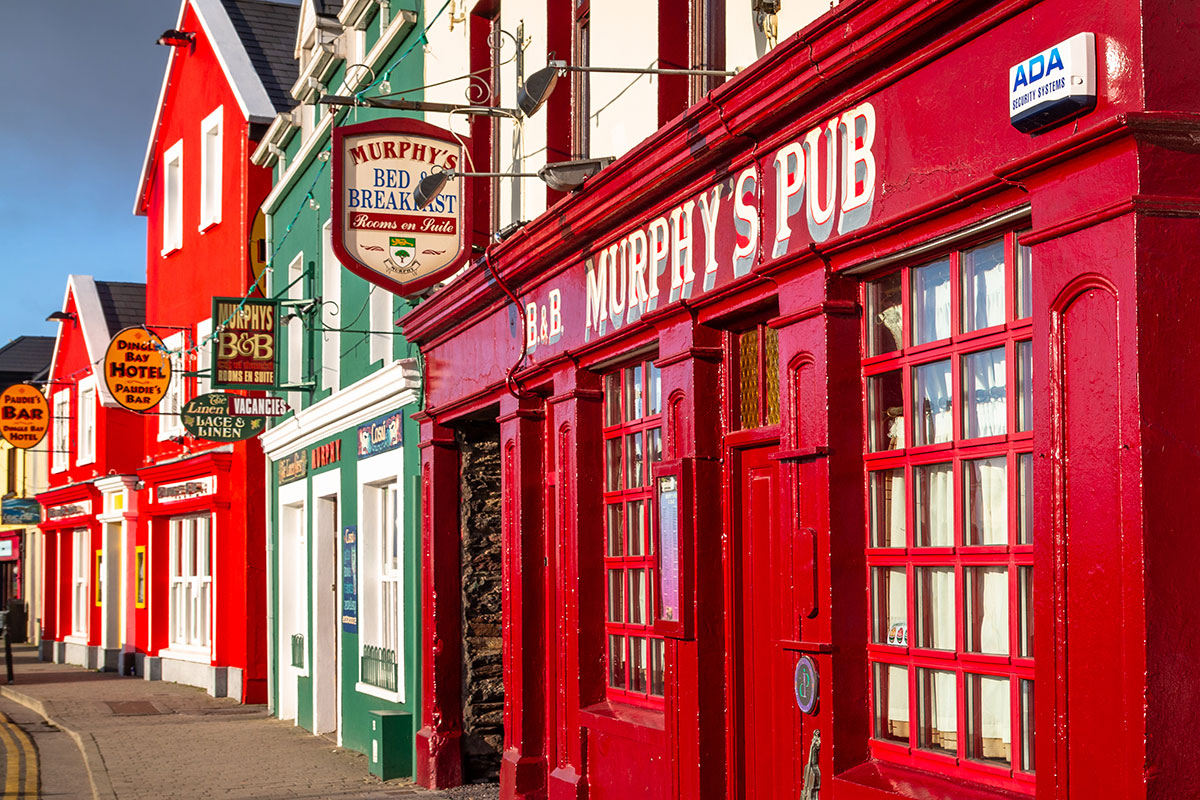 A sideways view of traditional Irish pubs in Dingle town on the Dingle peninsula in County Kerry, Ireland.