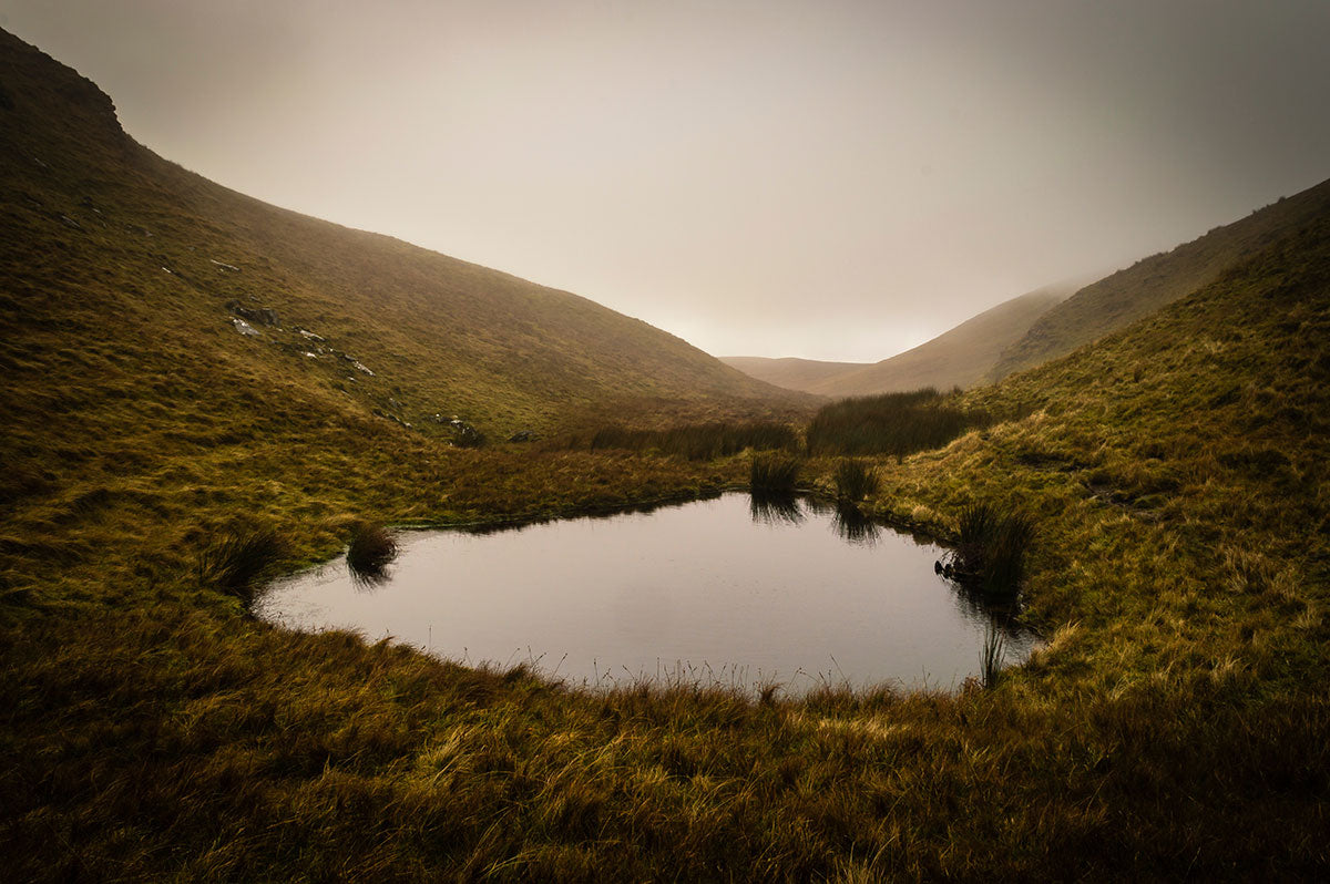 A misty and overcast view of the Rat Shaped Craigagh Lough in the Sperrin Mountains in Northern Ireland