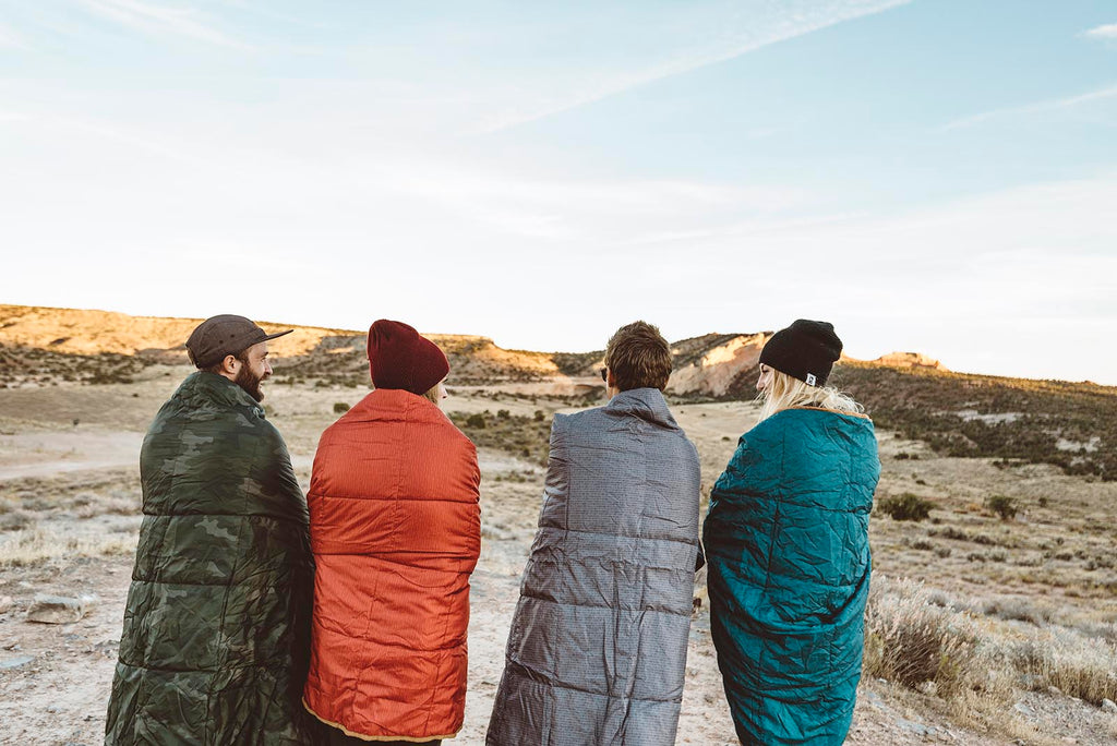 Friends wrapped in Kelty camp blankets