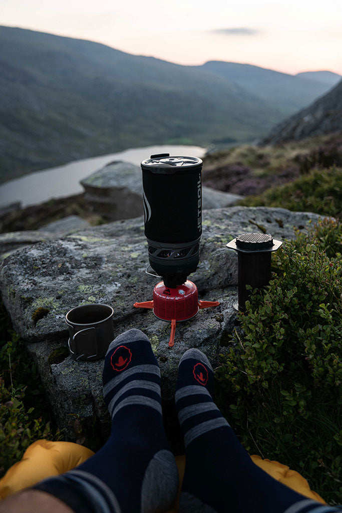 Man camping outdoors using Jetboil