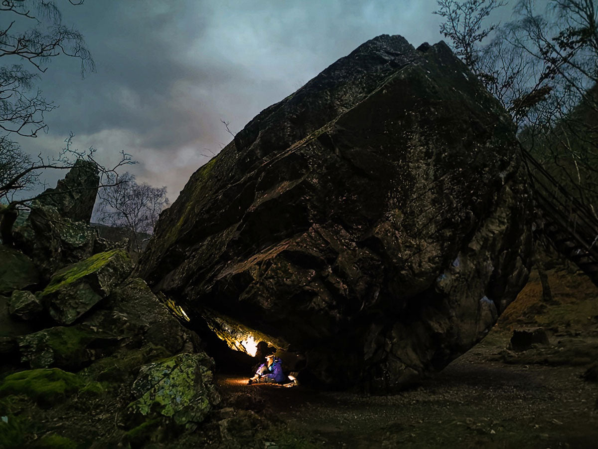 Sheltering underneath a colossal stone, taken by Kristian Brook
