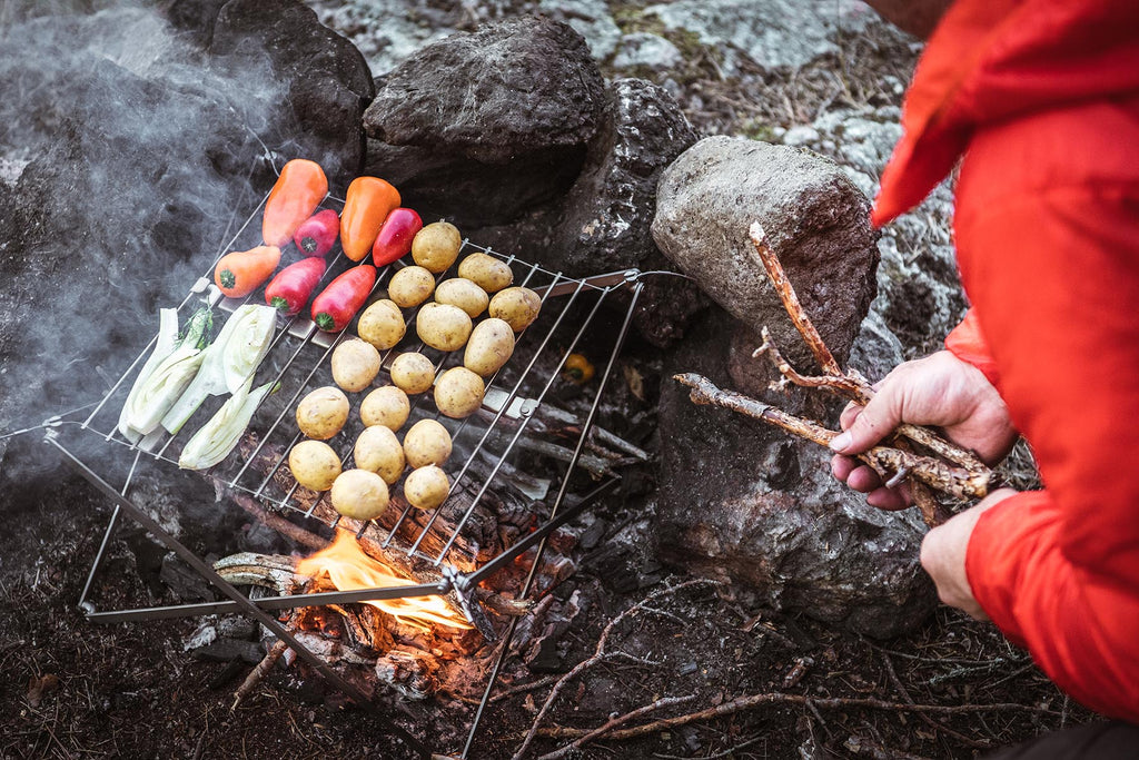 Vegetables cooking over the fire on a Wolf and Grizzly portable grill