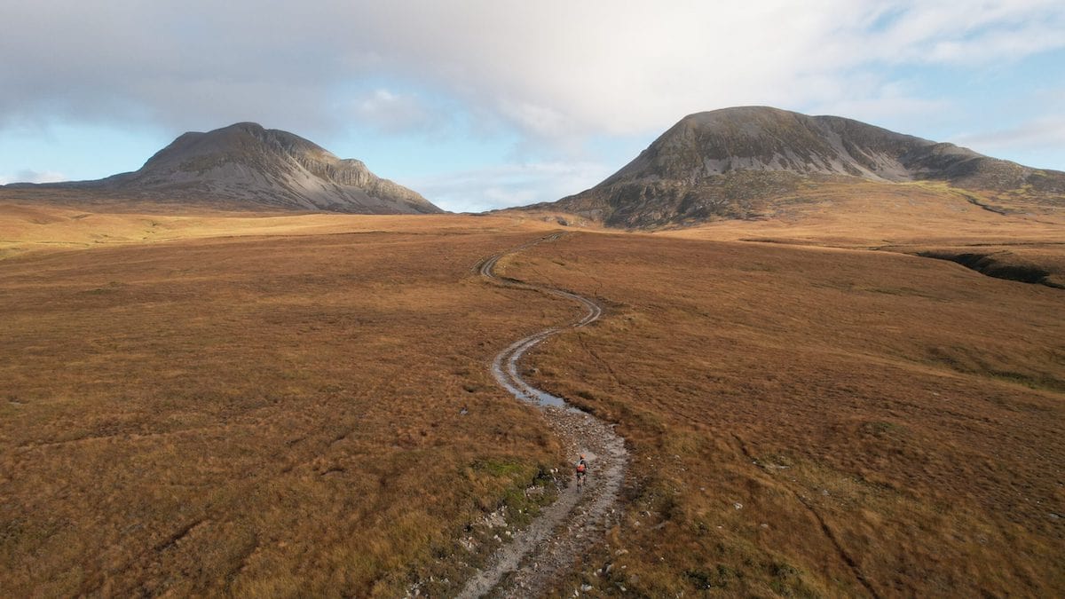 A cyclist travels down the mountain pass between the Paps of Jura, a group of mountains in the Inner Hebrides in Scotland. Credit: Bikepacking Scotland/ Markus Stitz