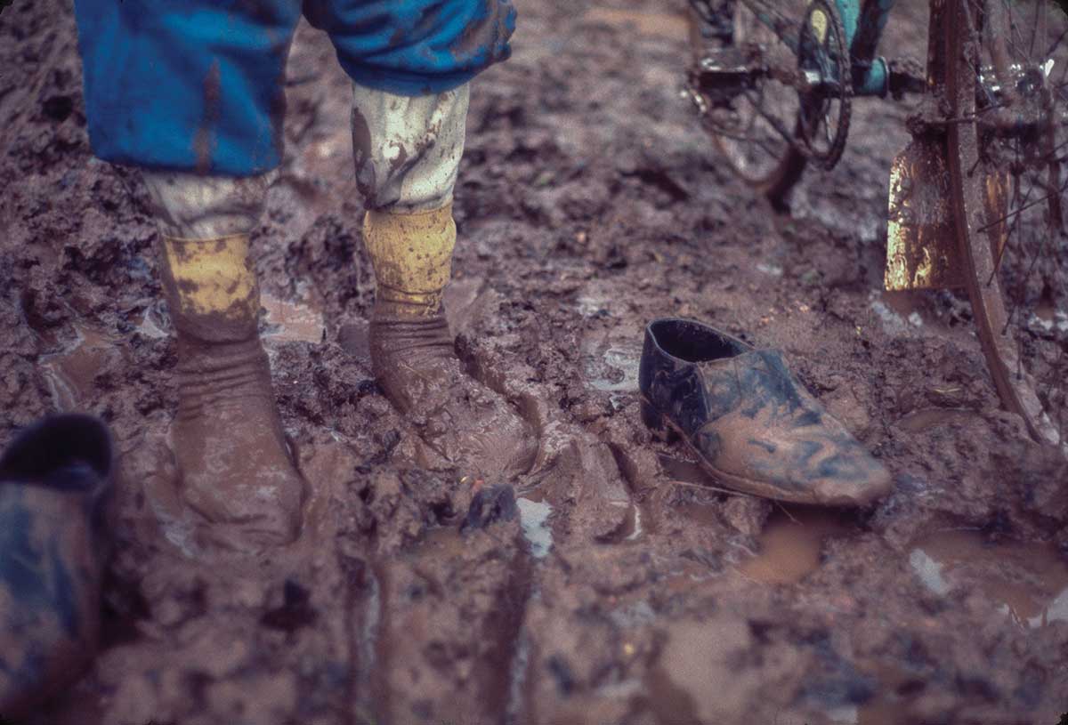 A Rough Stuff Fellowship image of a muddy bike, muddy socks and muddy shoes on a cycling trip.