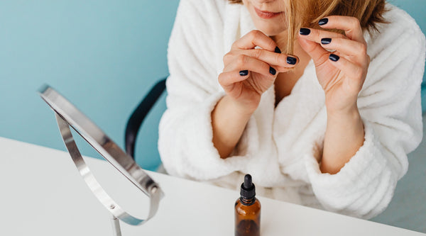 Woman applying natural hair mask oil on hair