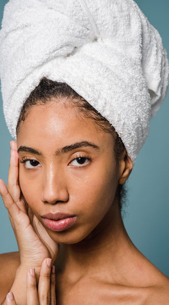 Woman holding face after doing natural skincare