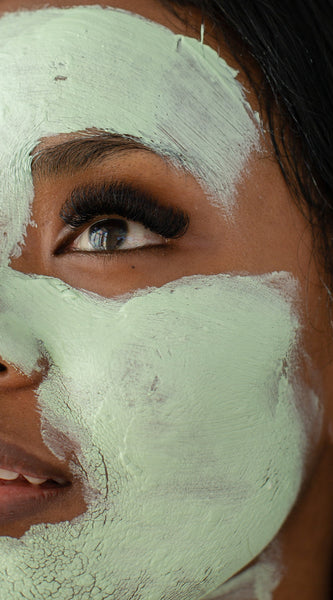 Woman with organic herbal facial mask with green chiretta