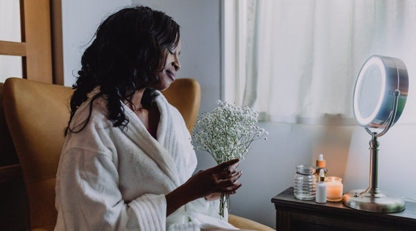 woman in robe enjoying self-care time