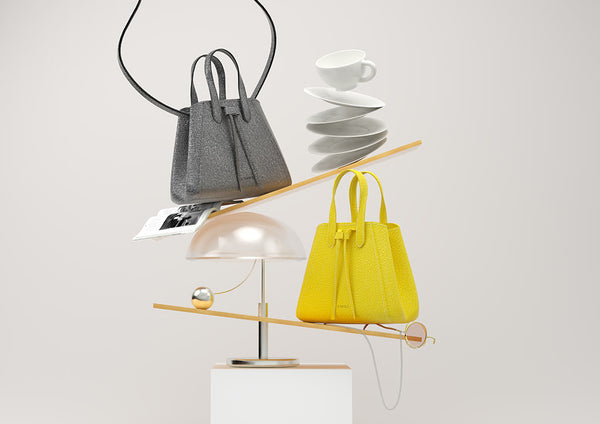 3D detailed composition of two mini leather bucket shape crossbody bags, gunmetal and lime colors, creating an imbalance with day-to-day regular objects