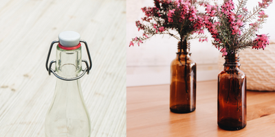 glass bottle with stopper being used as a vase for flowers 