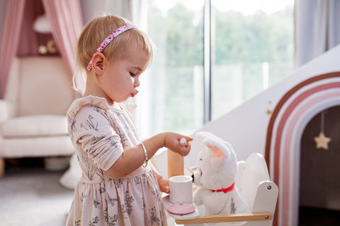 little girl playing with tea set wearing Libery of London fabric hair accessories headband from Bo and Bala